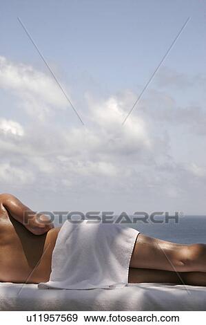 View of a female relaxing on a bed. View Large Photo Image Stock Photo - View of a female relaxing on a bed.. Fotosearch