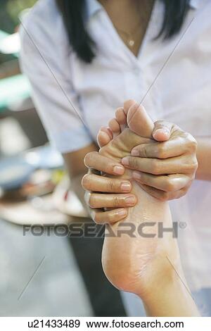 View of a masseuse massaging a female’s foot. View Large Photo Image Stock Photo - View of a masseuse massaging a female’s foot.. Fotosearch