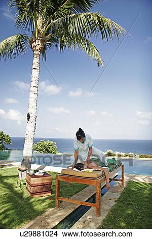 View of a masseuse massaging a teenage girl. View Large Photo Image Picture - View of a masseuse massaging a teenage girl.. Fotosearch