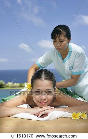View of a masseuse massaging a teenage girl. View Large Photo Image Stock Image - View of a masseuse massaging a teenage girl.. Fotosearch