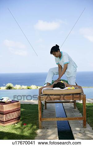 View of a masseuse massaging a teenage girl. View Large Photo Image Stock Image - View of a masseuse massaging a teenage girl.. Fotosearch