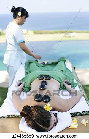 Stock Photo - View of a masseuse massaging a teenage girl.. Fotosearch