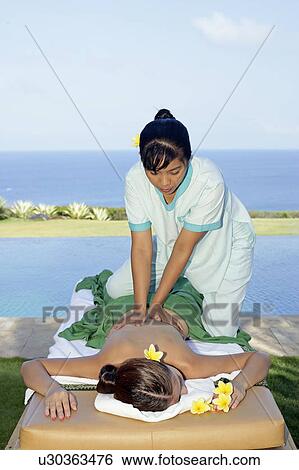 View of a masseuse massaging a teenage girl. View Large Photo Image Stock Photograph - View of a masseuse massaging a teenage girl.. Fotosearch