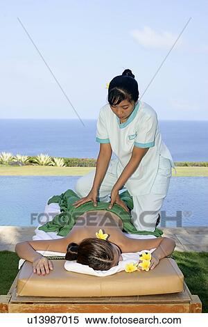 View of a masseuse massaging a teenage girl. View Large Photo Image Stock Photography - View of a masseuse massaging a teenage girl.. Fotosearch