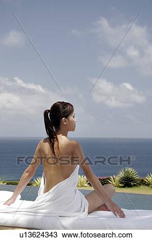 View of a seminude teenage girl sitting on a bed. View Large Photo Image Stock Image - View of a seminude teenage girl sitting on a bed.. Fotosearch
