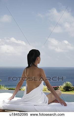 View of a seminude teenage girl sitting on a bed. View Large Photo Image Stock Photography - View of a seminude teenage girl sitting on a bed.. Fotosearch