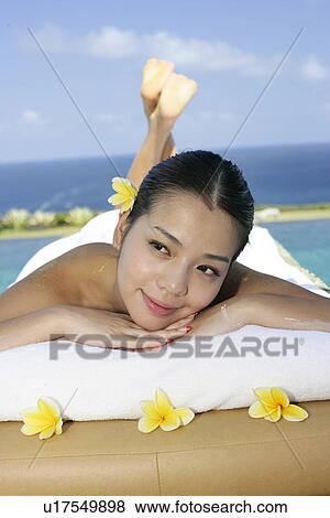 View of a teenage girl lying on a bed. View Large Photo Image Stock Photo - View of a teenage girl lying on a bed.. Fotosearch