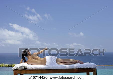 View of a teenage girl relaxing on a bed against the sea. View Large Photo Image Stock Image - View of a teenage girl relaxing on a bed against the sea.. Fotosearch
