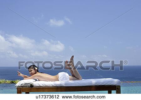View of a teenage girl relaxing on a bed. View Large Photo Image Stock Image - View of a teenage girl relaxing on a bed.. Fotosearch