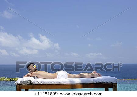 View of a teenage girl relaxing on a bed against the sea. View Large Photo Image Stock Photo - View of a teenage girl relaxing on a bed against the sea.. Fotosearch