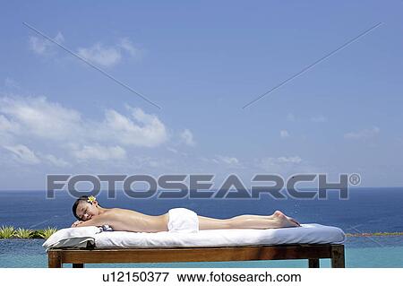 View of a teenage girl relaxing on a bed. View Large Photo Image Stock Photo - View of a teenage girl relaxing on a bed.. Fotosearch
