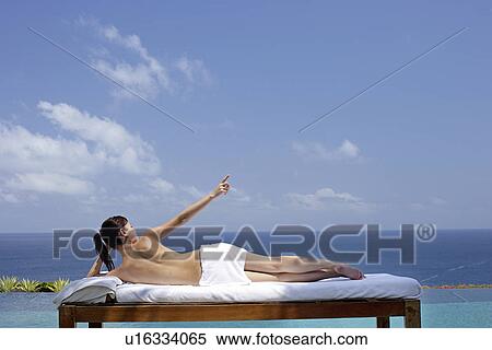 View of a teenage girl relaxing on a bed against the sea. View Large Photo Image Stock Photography - View of a teenage girl relaxing on a bed against the sea.. Fotosearch