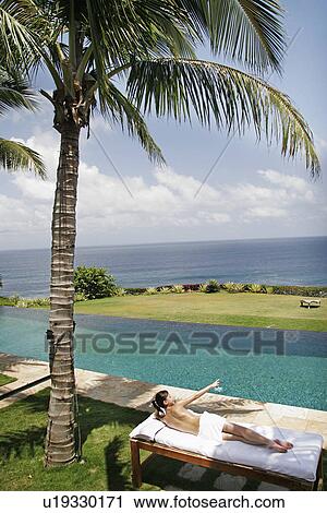 View of a teenage girl sun bathing. View Large Photo Image Stock Image - View of a teenage girl sun bathing.. Fotosearch