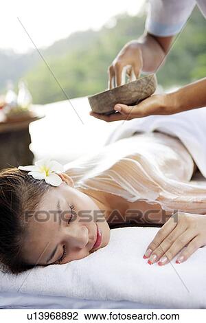 Stock Image - View of a teenage girl taking a massage.. Fotosearch
