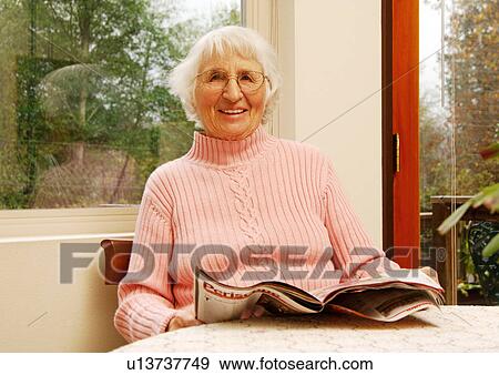 An elderly woman reading a magazine. View Large Photo Image Stock Photo - An elderly woman reading a magazine.. Fotosearch