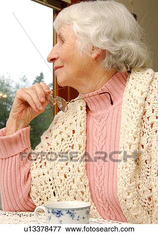 Close-up of a elderly woman absorbed in her thoughts. View Large Photo Image Stock Photo - Close-up of a elderly woman absorbed in her thoughts.. Fotosearch