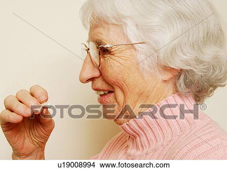 Close-up of a woman having her medicine. View Large Photo Image Picture - Close-up of a woman having her medicine.. Fotosearch