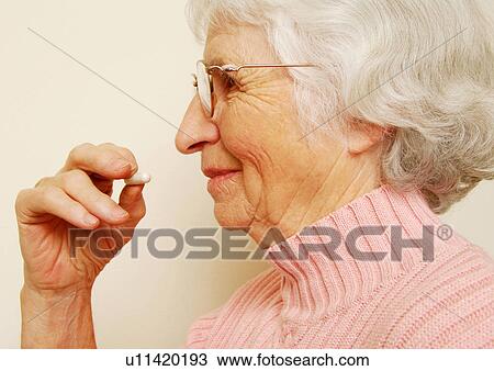 Close-up of a woman having her medicine. View Large Photo Image Stock Image - Close-up of a woman having her medicine.. Fotosearch