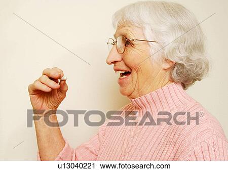 Close-up of a woman having her medicine. View Large Photo Image Stock Image - Close-up of a woman having her medicine.. Fotosearch