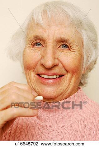 Close-up of a woman having her medicine. View Large Photo Image Stock Image - Close-up of a woman having her medicine.. Fotosearch