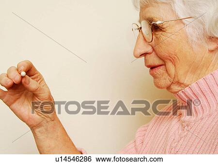 Close-up of a woman having her medicine. View Large Photo Image Stock Photograph - Close-up of a woman having her medicine.. Fotosearch