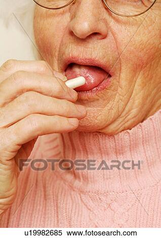 Close-up of an elderly woman having her medicine. View Large Photo Image Stock Photography - Close-up of an elderly woman having her medicine.. Fotosearch