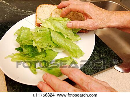 Picture - Close-up of cabbage leaves and bread slices on a plate.. Fotosearch
