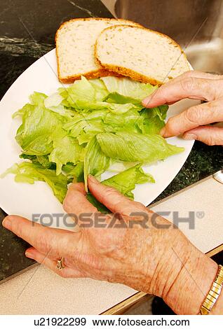 Stock Photo - Close-up of cabbage leaves and bread slices on a plate.. Fotosearch