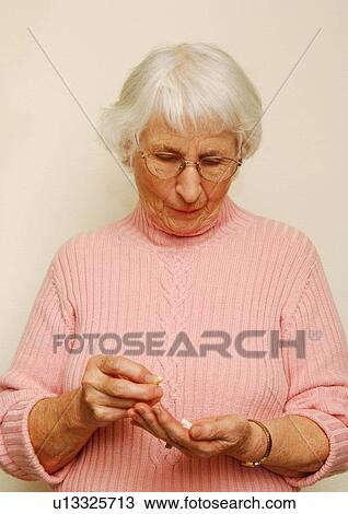Portrait of a woman holding her medicines. View Large Photo Image Stock Image - Portrait of a woman holding her medicines.. Fotosearch