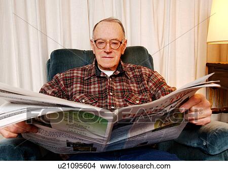 Portrait of an elderly man reading a newspaper. View Large Photo Image Picture - Portrait of an elderly man reading a newspaper.. Fotosearch