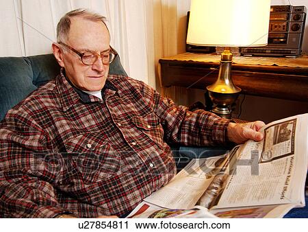 Portrait of an elderly man reading a newspaper. View Large Photo Image Stock Image - Portrait of an elderly man reading a newspaper.. Fotosearch
