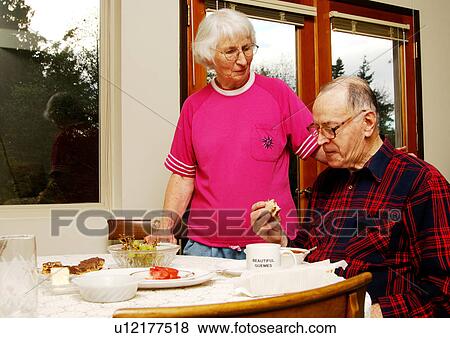 Stock Photo - View of an elderly couple at the breakfast table.. Fotosearch