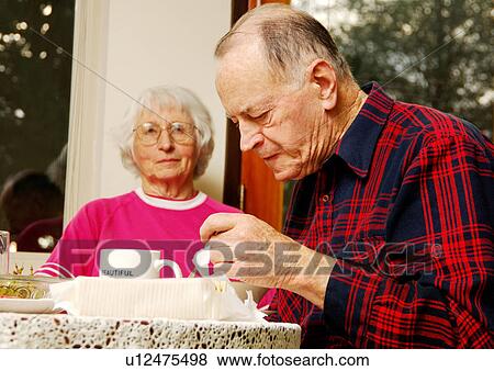 Stock Photo - View of an elderly couple at the breakfast table.. Fotosearch