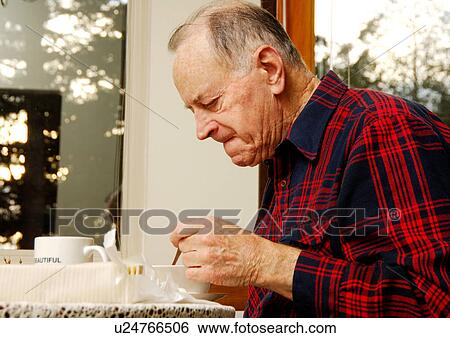 View of an elderly man having his breakfast. View Large Photo Image Stock Photograph - View of an elderly man having his breakfast.. Fotosearch