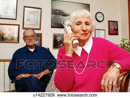 An elderly woman conversing on a cell phone. View Large Photo Image Stock Photo - An elderly woman conversing on a cell phone.. Fotosearch