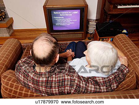 High angle view of an elderly couple watching television. View Large Photo Image Stock Image - High angle view of an elderly couple watching television.. Fotosearch