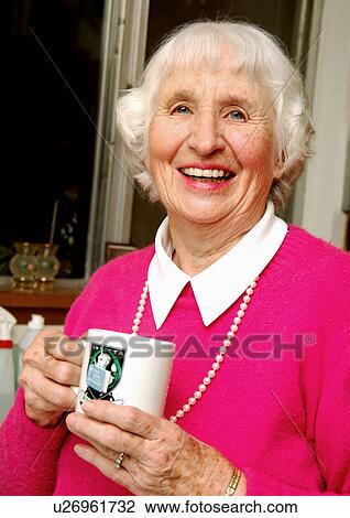 Portrait of an elderly woman holding a cup of tea. View Large Photo Image Stock Image - Portrait of an elderly woman holding a cup of tea.. Fotosearch