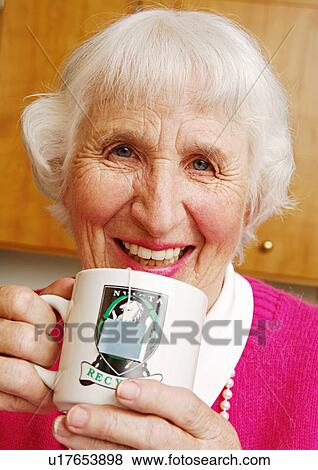 Portrait of an elderly woman sipping a cup of tea. View Large Photo Image Stock Photo - Portrait of an elderly woman sipping a cup of tea.. Fotosearch