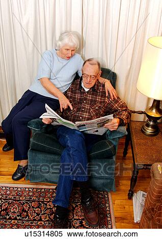 View of an elderly couple reading a newspaper. View Large Photo Image Stock Photography - View of an elderly couple reading a newspaper.. Fotosearch