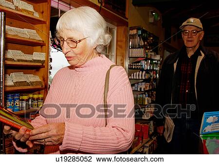 View of an elderly couple shopping in a supermarket. View Large Photo Image Stock Image - View of an elderly couple shopping in a supermarket.. Fotosearch