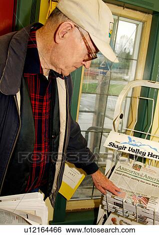 View of an elderly man checking out the newspapers. View Large Photo Image Stock Photograph - View of an elderly man checking out the newspapers.. Fotosearch