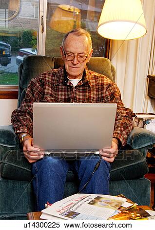 View of an elderly man surfing on his laptop. View Large Photo Image Stock Photography - View of an elderly man surfing on his laptop.. Fotosearch