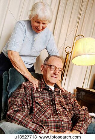 View of an elderly woman massaging her husbands shoulders. View Large Photo Image Stock Image - View of an elderly woman massaging her husbands shoulders.. Fotosearch