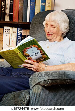 View of an elderly woman reading a book. View Large Photo Image Stock Photo - View of an elderly woman reading a book.. Fotosearch