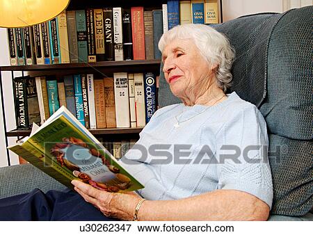 View of an elderly woman reading a book. View Large Photo Image Stock Photo - View of an elderly woman reading a book.. Fotosearch