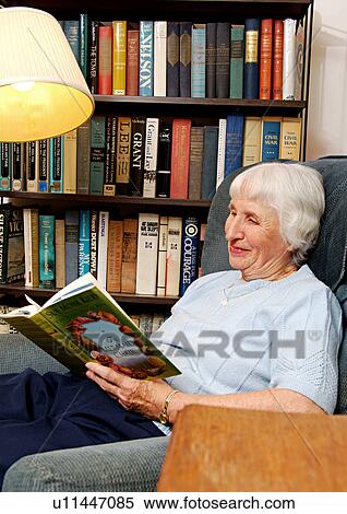 View of an elderly woman reading a book. View Large Photo Image Stock Photography - View of an elderly woman reading a book.. Fotosearch
