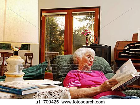 View of an elderly woman reading a book. View Large Photo Image Stock Photography - View of an elderly woman reading a book.. Fotosearch