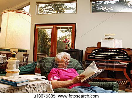 View of an elderly woman reading a book. View Large Photo Image Stock Photography - View of an elderly woman reading a book.. Fotosearch