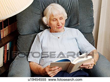 View of an elderly woman reading a book. View Large Photo Image Stock Photography - View of an elderly woman reading a book.. Fotosearch