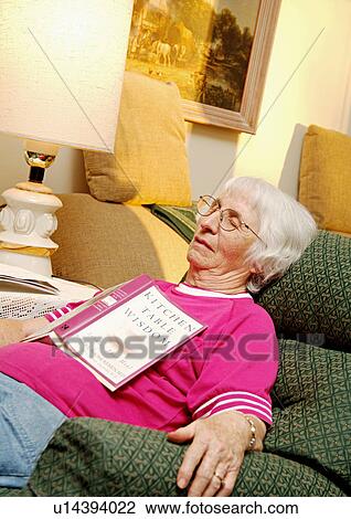 Stock Image - View of an elderly woman taking peaceful a nap.. Fotosearch